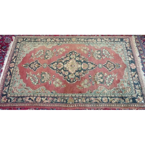 629 - A Persian Rug, with central medallion, 55in (140cm) wide x 88in (223.5cm) long.