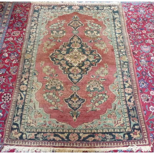 629 - A Persian Rug, with central medallion, 55in (140cm) wide x 88in (223.5cm) long.