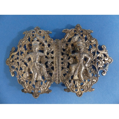 64 - An Indian silver Nurse's Buckle, unmarked but tested, decorated with a central figure in a pierced f... 