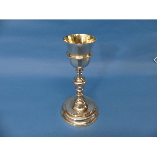 80 - A 19thC German silver Goblet Chalice, with a stepped circular foot and long knopped stem, gilt inter... 