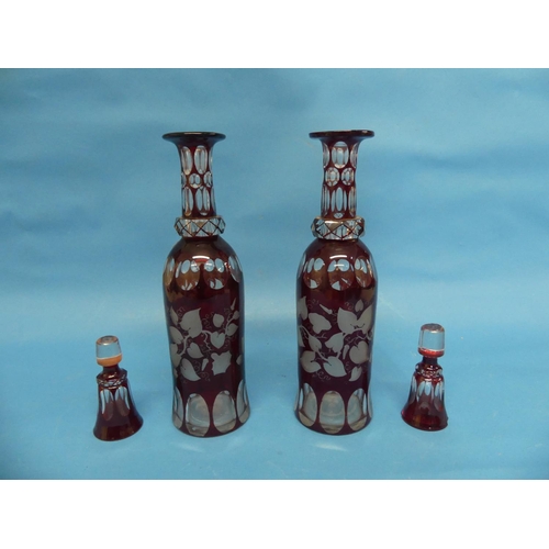 104 - A pair of early 20thC Bohemian ruby flash Decanters, bottle shape, one with chipped stopper, 13½in (... 