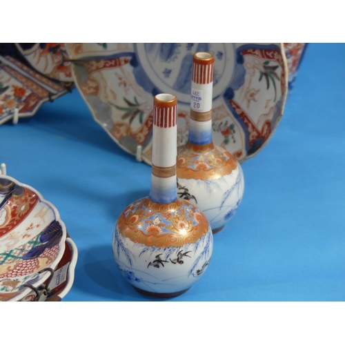 106 - A pair of Japanese imari porcelain Vases, of spiral fluted baluster form, 15in (38cm) high, together... 