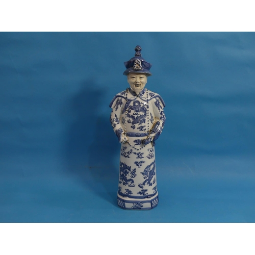 111 - A 20th century Chinese blue and white porcelain figure of an Elder, behatted and holding a pipe, his... 