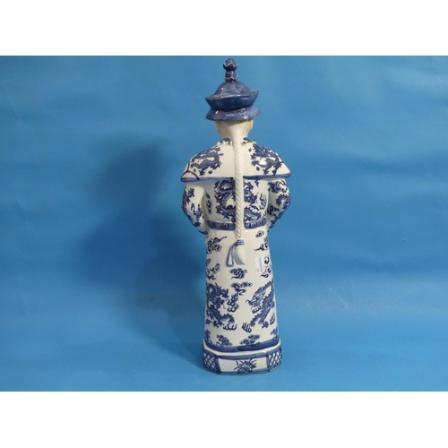 111 - A 20th century Chinese blue and white porcelain figure of an Elder, behatted and holding a pipe, his... 