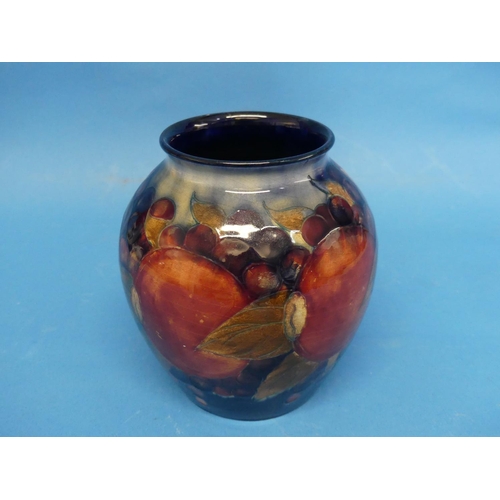 122 - A Walter Moorcroft 'Pomegranate' pattern Vase, the tube-lined design, with impressed marks and signa... 