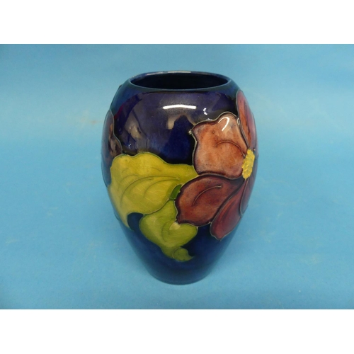 126 - A Moorcroft 'Clematis' pattern Ovoid Vase, the tube-line design with impressed marks to the base, in... 