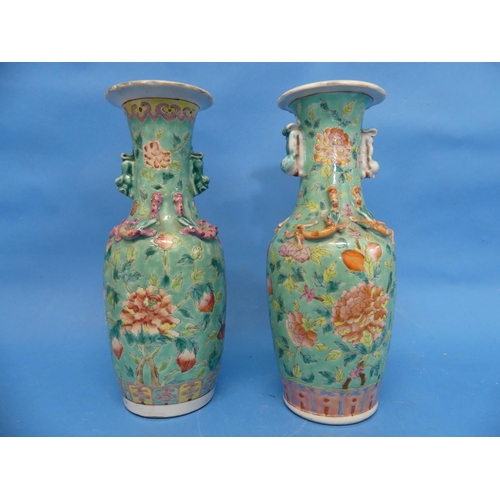 167 - A pair of early 20th century Chinese famille rose porcelain Vases, green ground, applied with fu dog... 