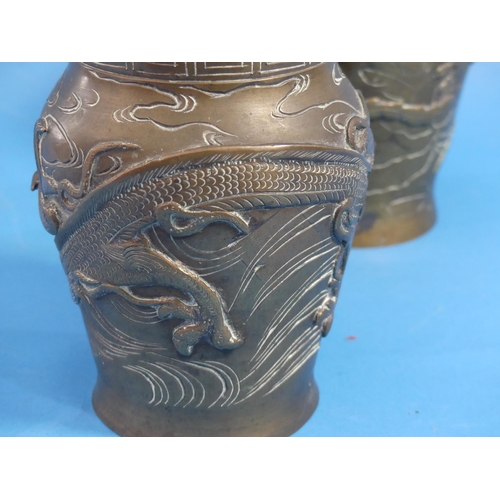 186 - A pair of late 19thC oriental bronze baluster Vases, each moulded in relief in the Japanese style wi... 