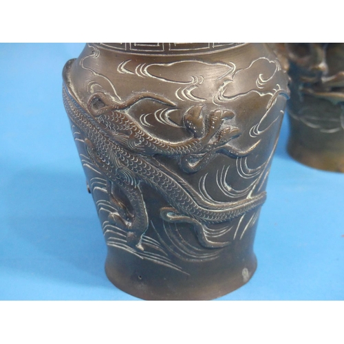 186 - A pair of late 19thC oriental bronze baluster Vases, each moulded in relief in the Japanese style wi... 