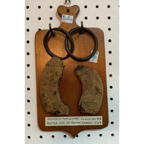 273 - East Devon interest: two parts of a broken horseshoe, in very rusty condition, mounted on a wooden w... 