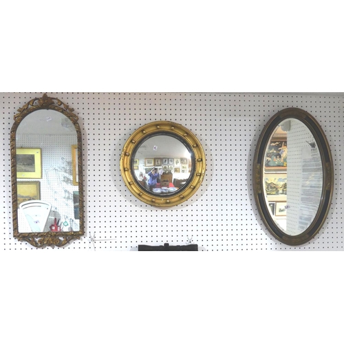 319 - A gilt and black framed oval Wall Mirror, with bevelled glass, 27½in (70cm) long, together with a gi... 