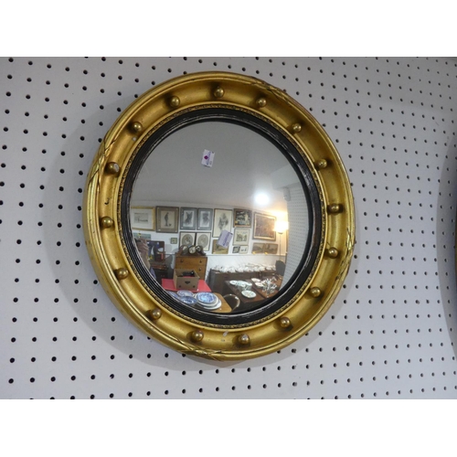 319 - A gilt and black framed oval Wall Mirror, with bevelled glass, 27½in (70cm) long, together with a gi... 