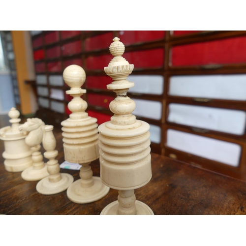 321 - A 19thC ivory Chess Set, with natural coloured and red stained pieces, King 4in (10cm) high, complet... 