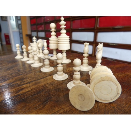 321 - A 19thC ivory Chess Set, with natural coloured and red stained pieces, King 4in (10cm) high, complet... 