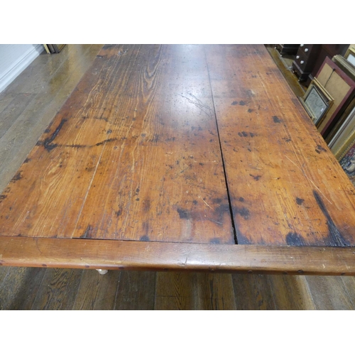 335 - A large early 20thC pine plank top Kitchen Table, with three frieze drawers, 124½in (316cm) long, 38... 