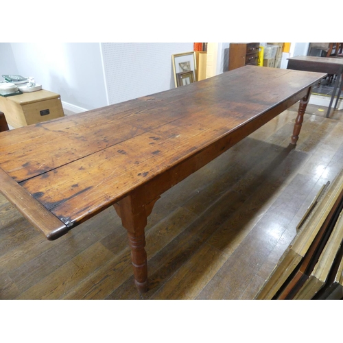 335 - A large early 20thC pine plank top Kitchen Table, with three frieze drawers, 124½in (316cm) long, 38... 