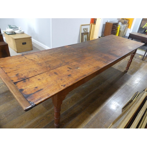 335 - A large early 20thC pine plank top Kitchen Table, with three frieze drawers, 124½in (316cm) long, 38... 