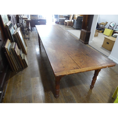 335 - A large early 20thC pine plank top Kitchen Table, with three frieze drawers, 124½in (316cm) long, 38... 