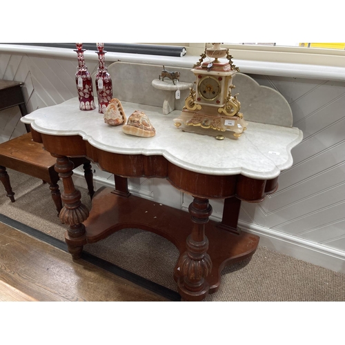 354 - A late Victorian mahogany marble-topped Washstand, of serpentine form with raised back above a friez... 