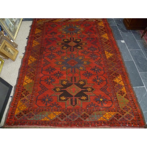 397 - Tribal rugs; an old Caucasian Kazak red ground rug, coarsely woven and hand knotted with date cartou... 