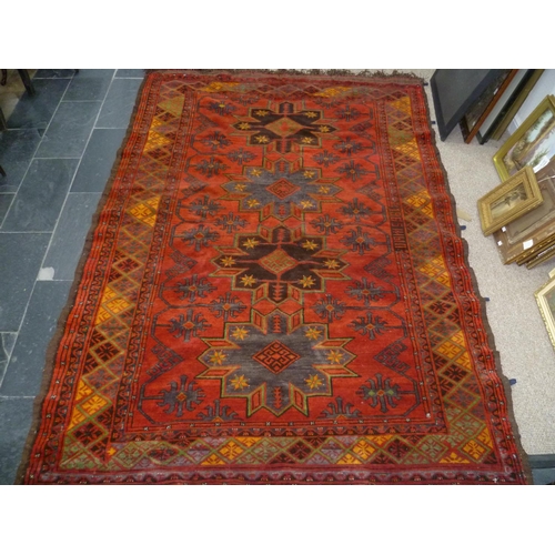 397 - Tribal rugs; an old Caucasian Kazak red ground rug, coarsely woven and hand knotted with date cartou... 