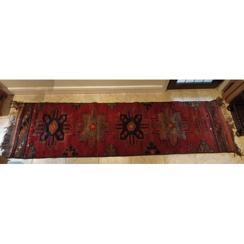 398 - Tribal rugs; the central strip of an old Caucasian Kazak red ground rug, formed into a runner by ove... 