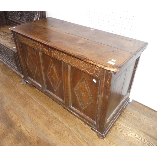 399 - A 17th century and later oak Coffer, the hinged lid above carved frieze and three carved panels, on ... 