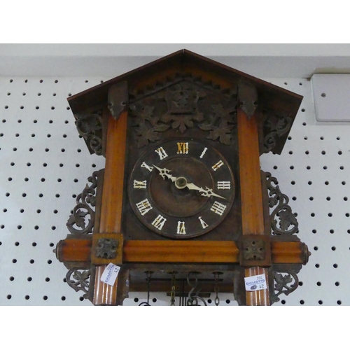 400 - An early 20th century Black Forest Cuckoo Clock, with pendulum and two weights, the case 12½in (32cm... 