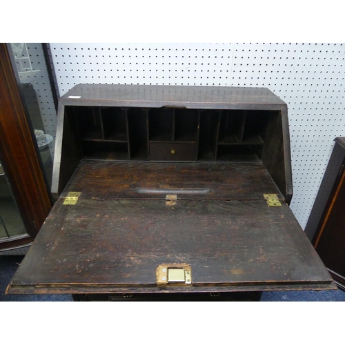 402 - An early 20thC oak Bureau, with fall front top above three long drawers, raised on bracket feet, 30i... 