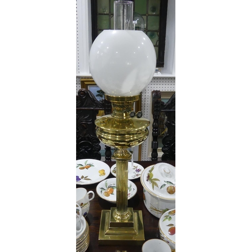 409 - An Edwardian brass Oil Lamp, of classical column form on stepped square base, with white glass shade... 