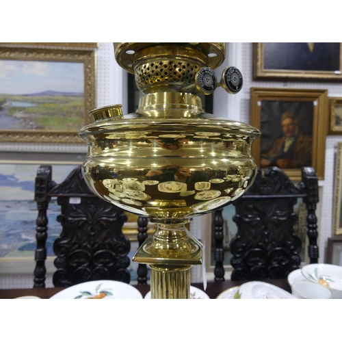 409 - An Edwardian brass Oil Lamp, of classical column form on stepped square base, with white glass shade... 