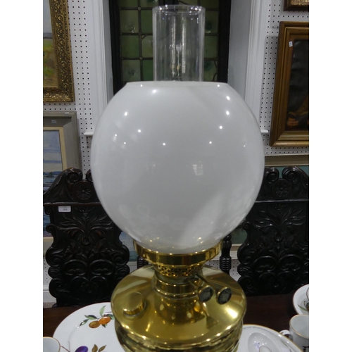 409 - An Edwardian brass Oil Lamp, of classical column form on stepped square base, with white glass shade... 