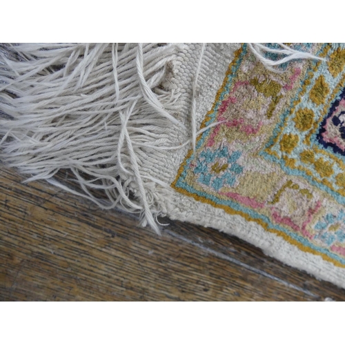 416 - Tribal Rugs: A Kashmiri silk rug, cream ground woven with black and pink traditional patterns, pile ... 