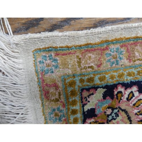 416 - Tribal Rugs: A Kashmiri silk rug, cream ground woven with black and pink traditional patterns, pile ... 