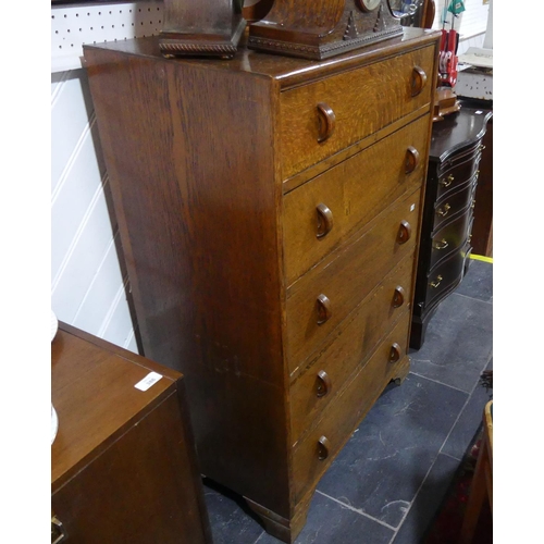 433 - A mid-20th century oak Chest of Drawers, by Herbert E. Gibbs, the five graduated drawers with half-h... 