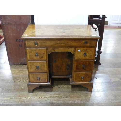 440 - A George III style walnut kneehole Desk, the rectangular top with moulded edge above a frieze drawer... 