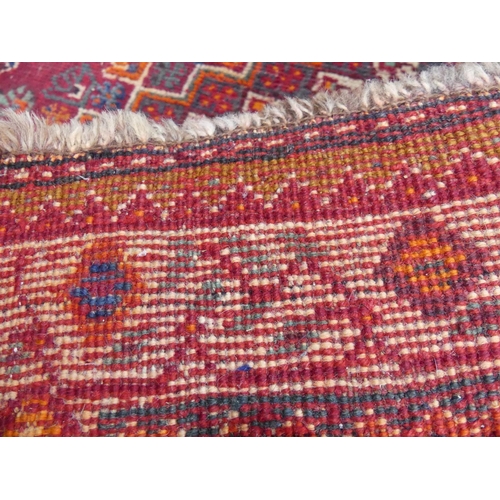 450 - Tribal rugs; a Persian Qashqai red and blue ground rug, the whole woven with stylised tree of life a... 