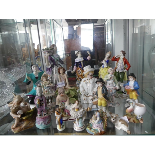 78 - A quantity of Figurines, mostly continental porcelain figural groups, but also including Hummel, pot... 