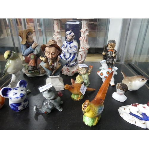 78 - A quantity of Figurines, mostly continental porcelain figural groups, but also including Hummel, pot... 