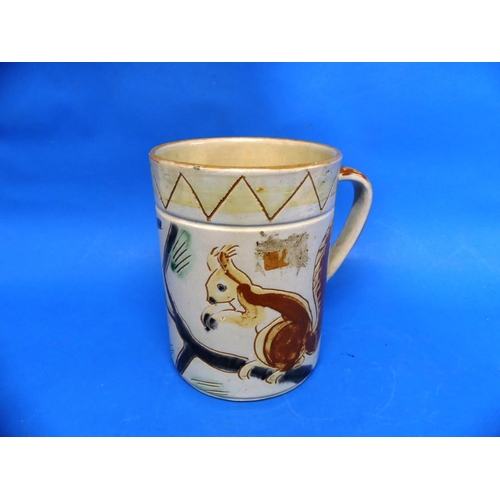 82 - A large Brannam Pottery Mug, naively adorned in sgrafitto decoration each side with red squirrels on... 