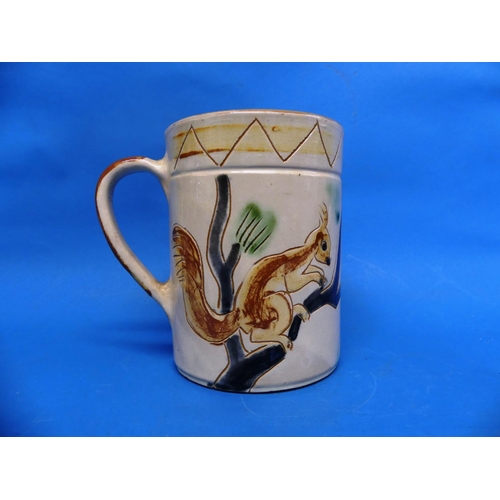 82 - A large Brannam Pottery Mug, naively adorned in sgrafitto decoration each side with red squirrels on... 