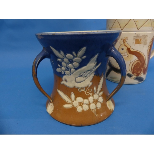 82 - A large Brannam Pottery Mug, naively adorned in sgrafitto decoration each side with red squirrels on... 