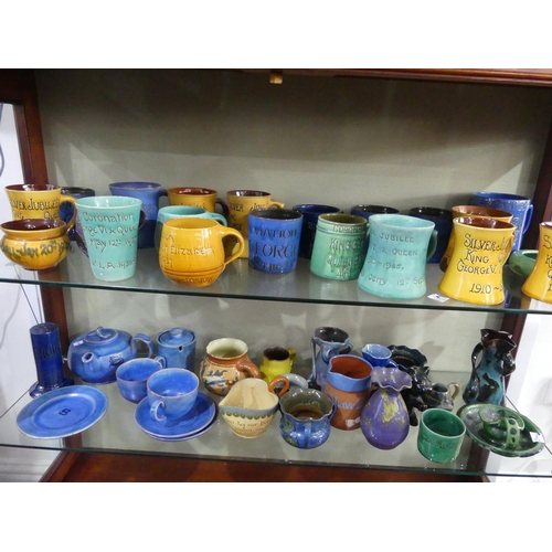 84 - A large collection of Brannam Pottery Commemorative Ware, together with a plain blue Baron Barnstapl... 