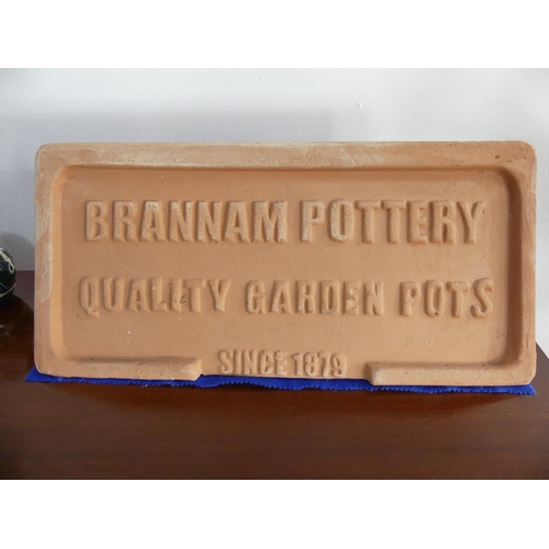 99a - A vintage Brannam Pottery terracotta Advertising Plaque, 20in wide x 10in high (51cm x 25.5cm).