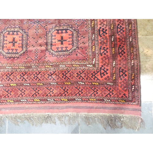 395 - Tribal rugs; an old Turkmen, possibly Ersari, red ground rug, finely woven and hand knotted with rep... 