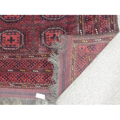 395 - Tribal rugs; an old Turkmen, possibly Ersari, red ground rug, finely woven and hand knotted with rep... 