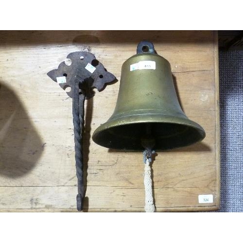 445 - A vintage brass Ships Bell, with associated iron bracket, bell: 11in (28cm) high x 10in (25.5cm) dia... 