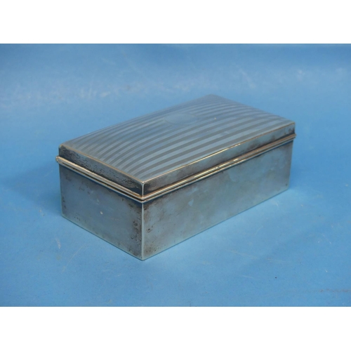 28 - A George VI silver Cigarette Box, by A.& J. Zimmerman Ltd, hallmarked Birmigham, 1945, of wood-l... 