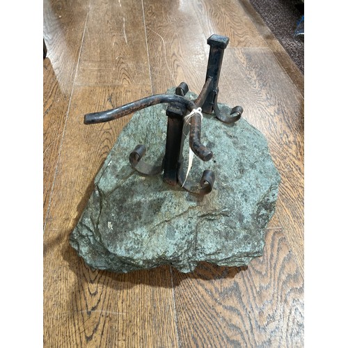 494 - A vintage cast iron Boot Jack, the Jack raised on a plinth of stone, 15in (38cm) long x 8in (20cm) h... 