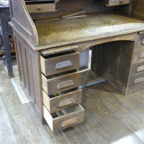 296 - An early 20thC oak Tambour-front Roll Top Desk, by M. W. Edgley & Co, the rolling top exposing f... 